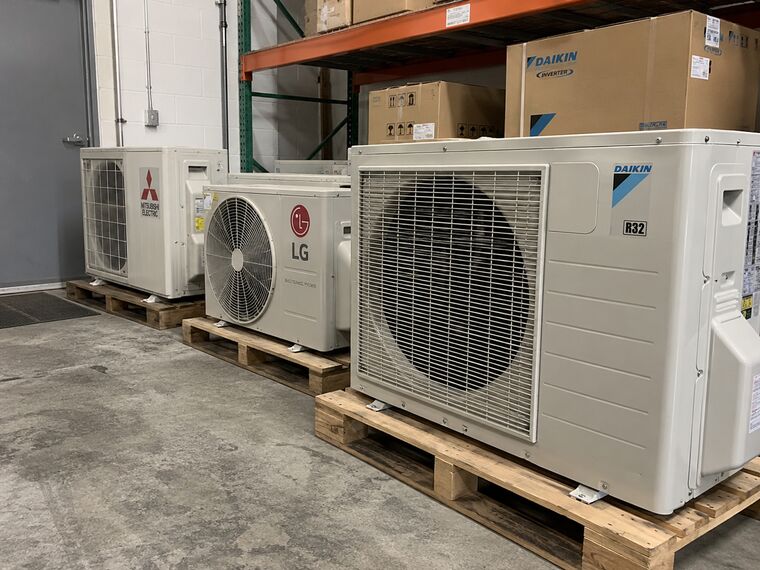 Mitsubishi Electric, LG and Daikin mini-split outdoor units on pallets in our warehouse
